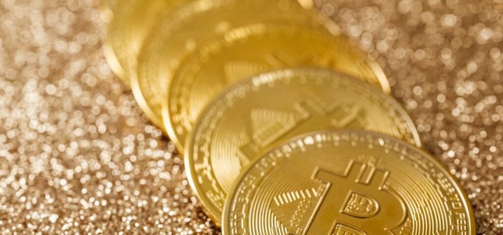 Golden Bitcoin coins symbolizing Bitcoin versus gold as an investment choice for Pakistanis