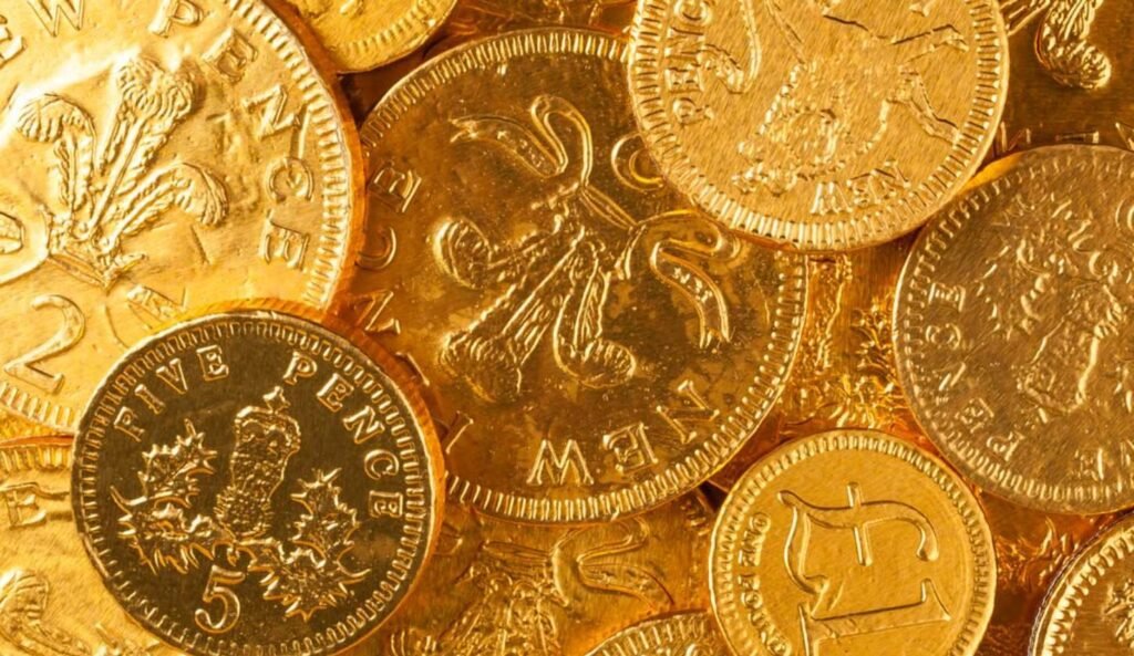 Close-up of gold coins representing 24K and 22K gold purity comparison in Pakistan