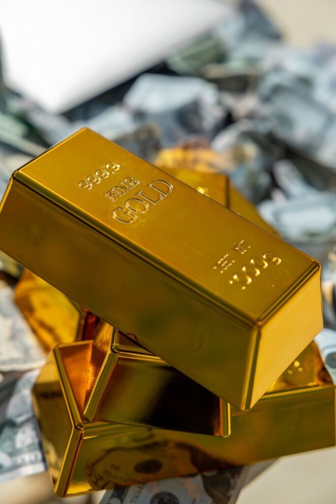 24 Karat Gold bars stacked on cash representing pure gold investment