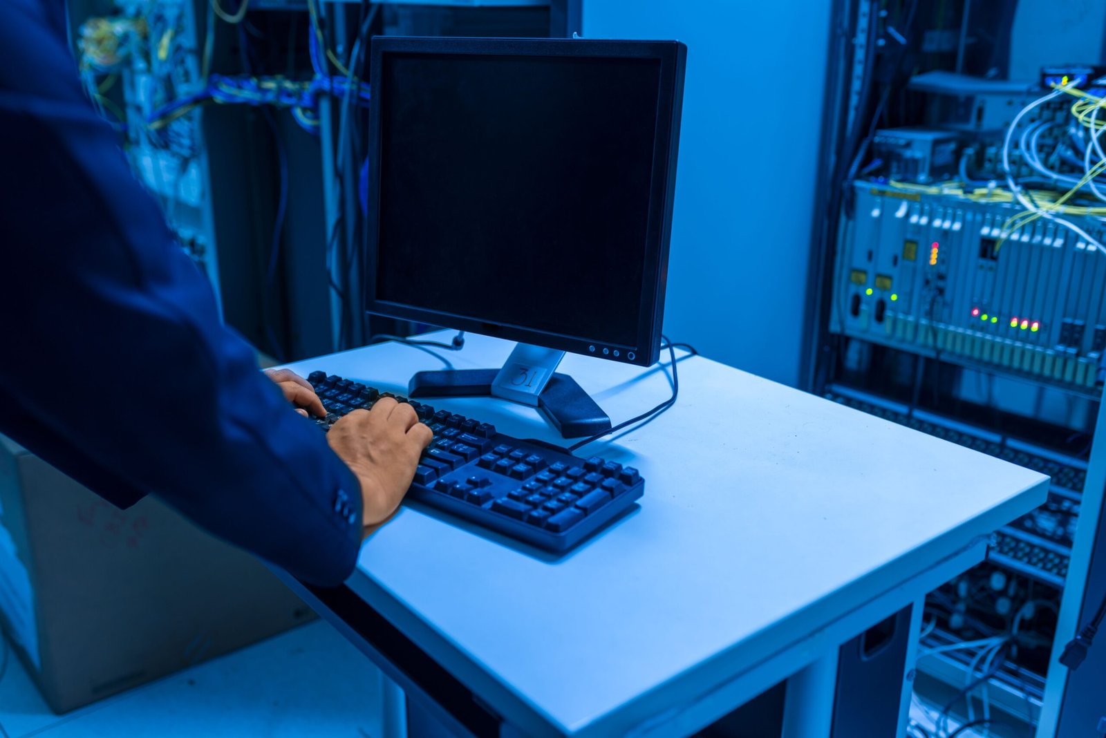 IT technician working in a data center server room supporting AI infrastructure