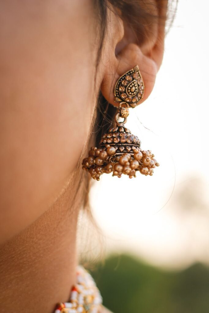Gold Earring Price in Pakistan shown through an elegant gold jhumka earring