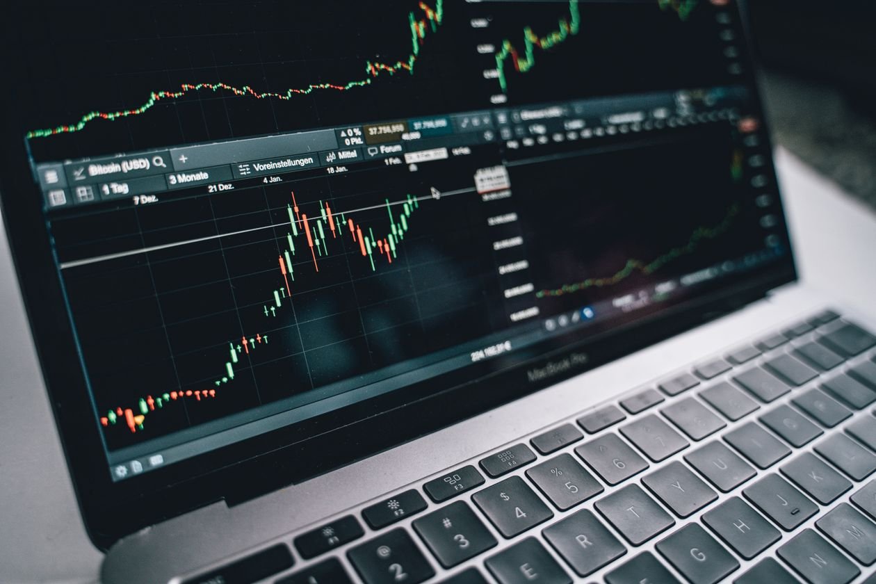 Laptop displaying a stock market chart, representing institutional investment monitoring