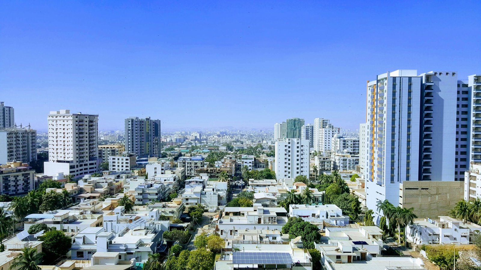 White and grey concrete residential buildings in a Karachi neighbourhood during daytime