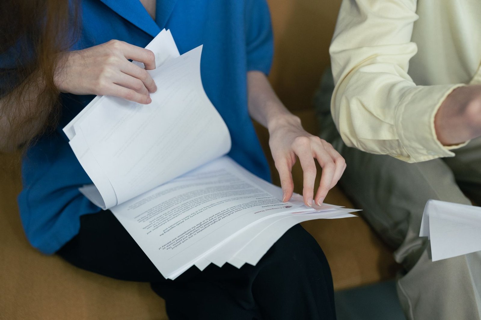 Buyers reviewing property files and NOC documents before signing