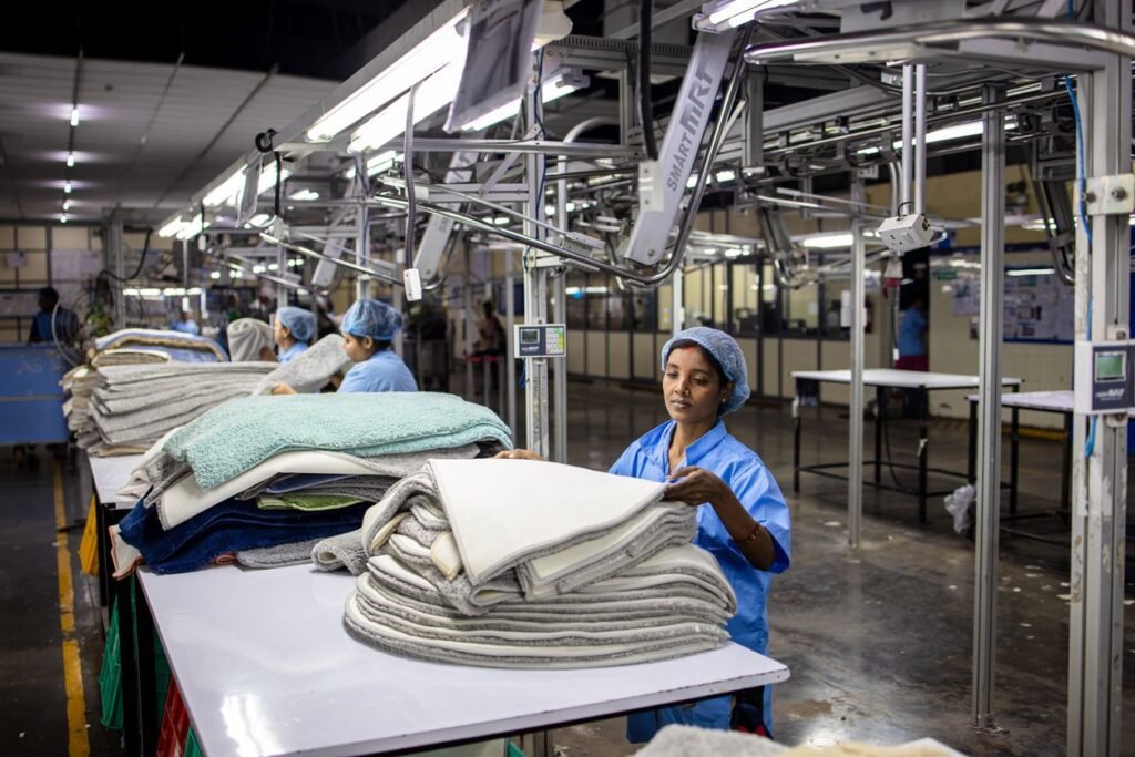 Pakistan economic growth phase 2026 illustrated by textile export factory workers sorting fabrics indoors