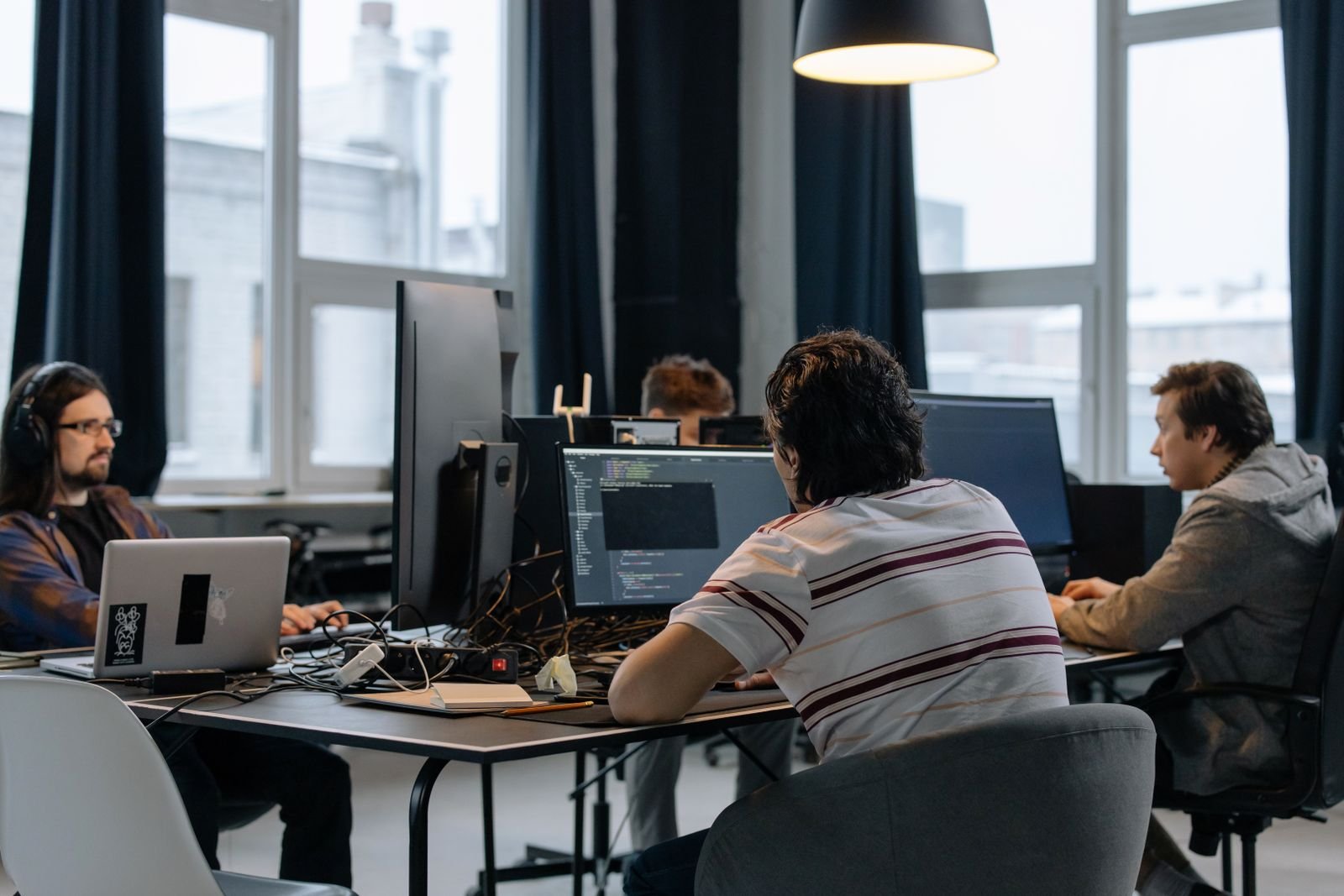 Pakistan exports team of software developers working in a modern tech office