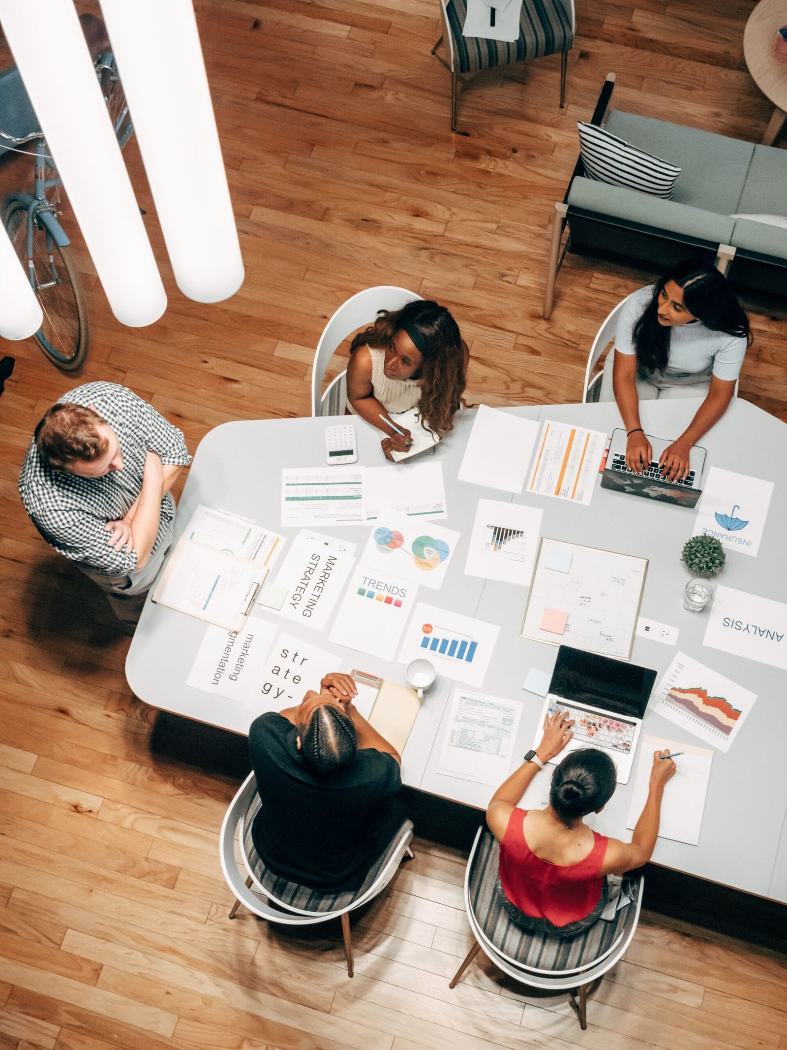 Diverse startup team collaborating around a table on an early-stage business plan