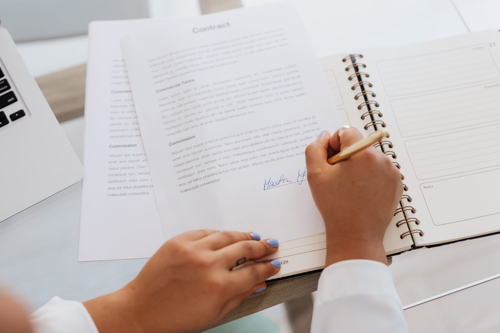 Buyer signing property purchase documents for a housing society file transfer