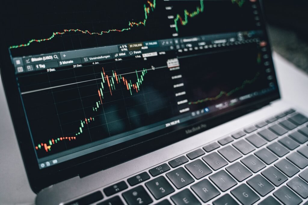 PVARA crypto licensing Pakistan 2026 - trader monitoring cryptocurrency and stock market charts on a laptop