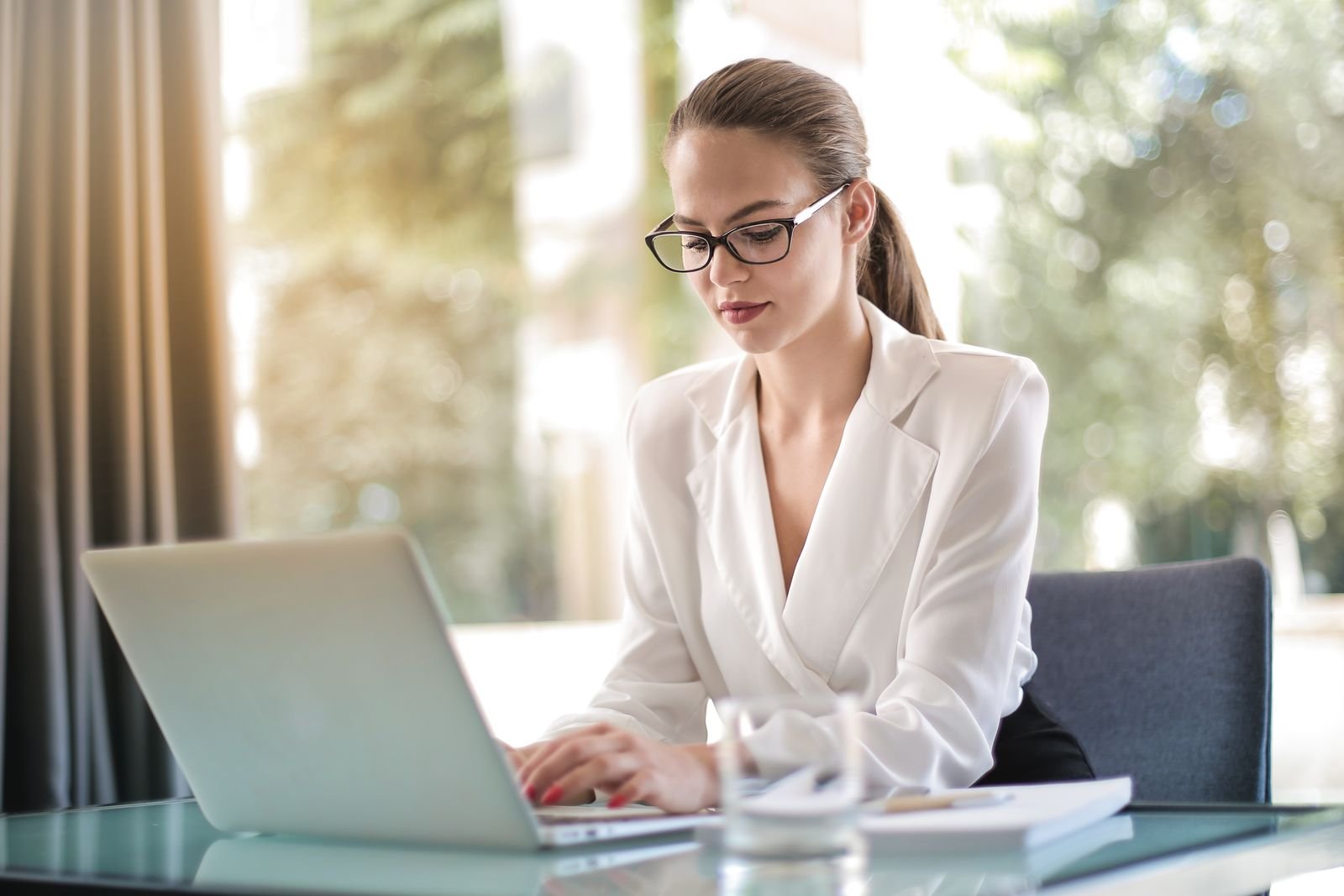 Startup founder working at a laptop, reviewing venture capital funding documents at her desk