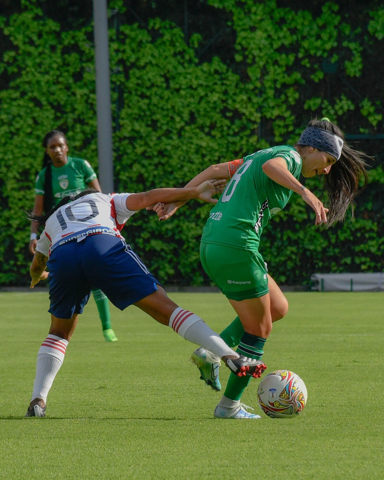 Women's sports investment boom 2026 shown through female soccer players competing for the ball in a professional match