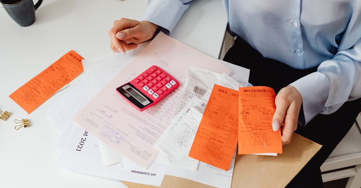 Woman reviewing receipts and calculating household expenses amid rising prices