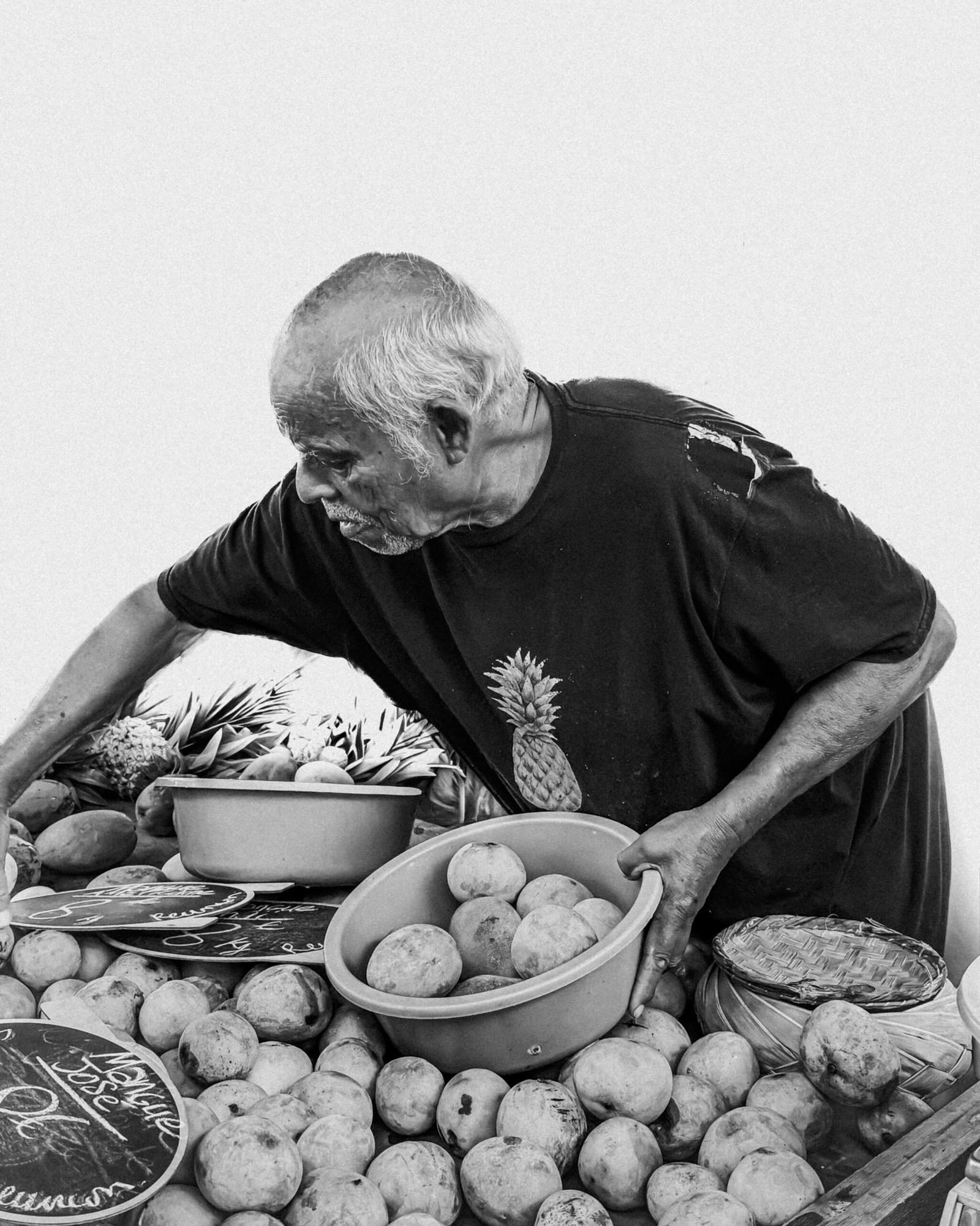 Vendor arranging fruit at a market stall, the kind of small business feeling the squeeze from rising food costs