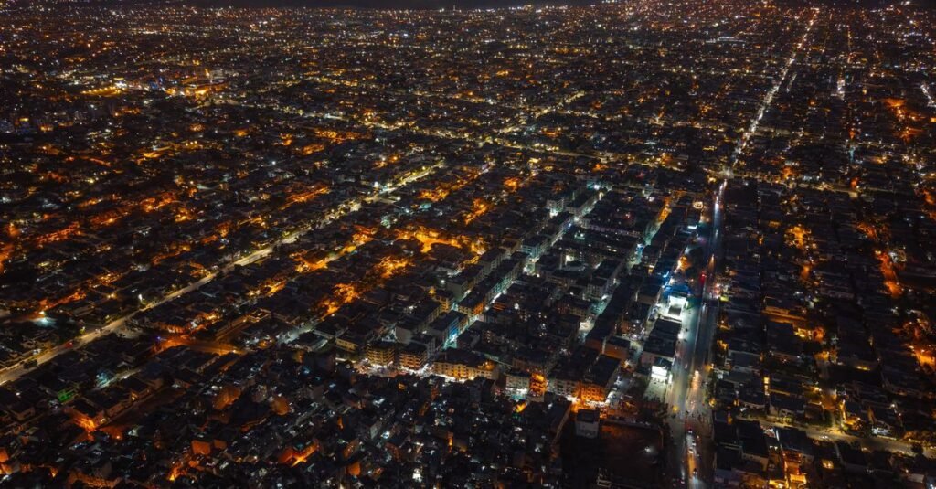 Karachi skyline at night representing the Naya Nazimabad REIT public subscription opening for investors