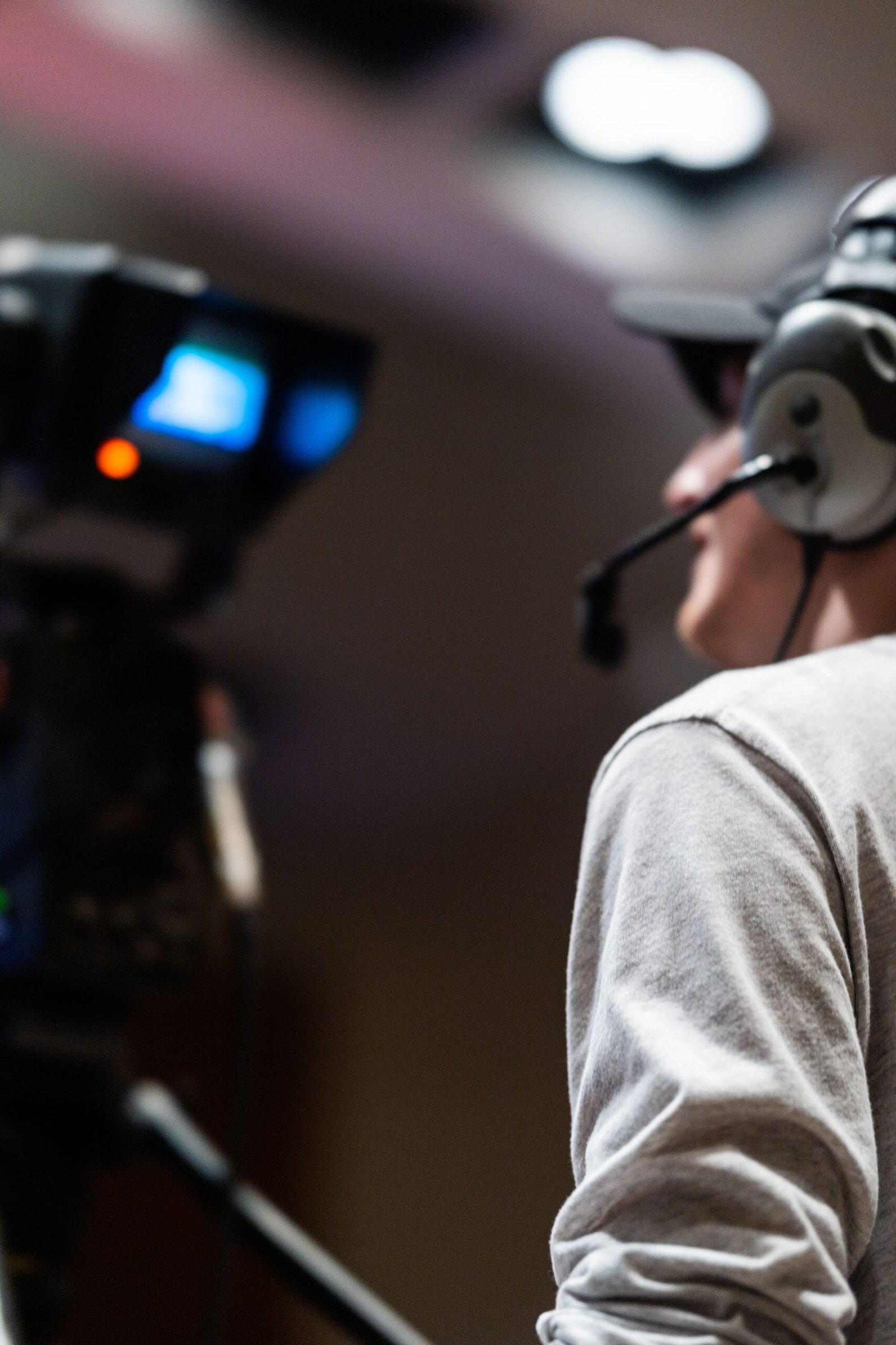 Broadcast camera operator filming live sports coverage