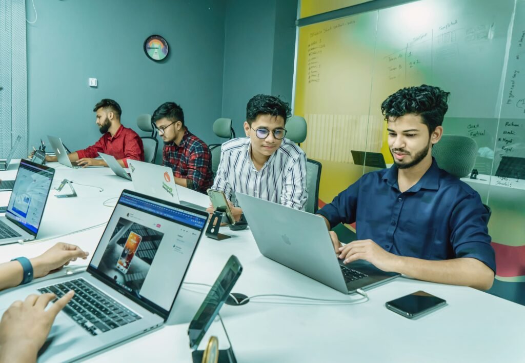 Pakistani AI startup funding 2026: founders working on laptops in a modern tech startup office